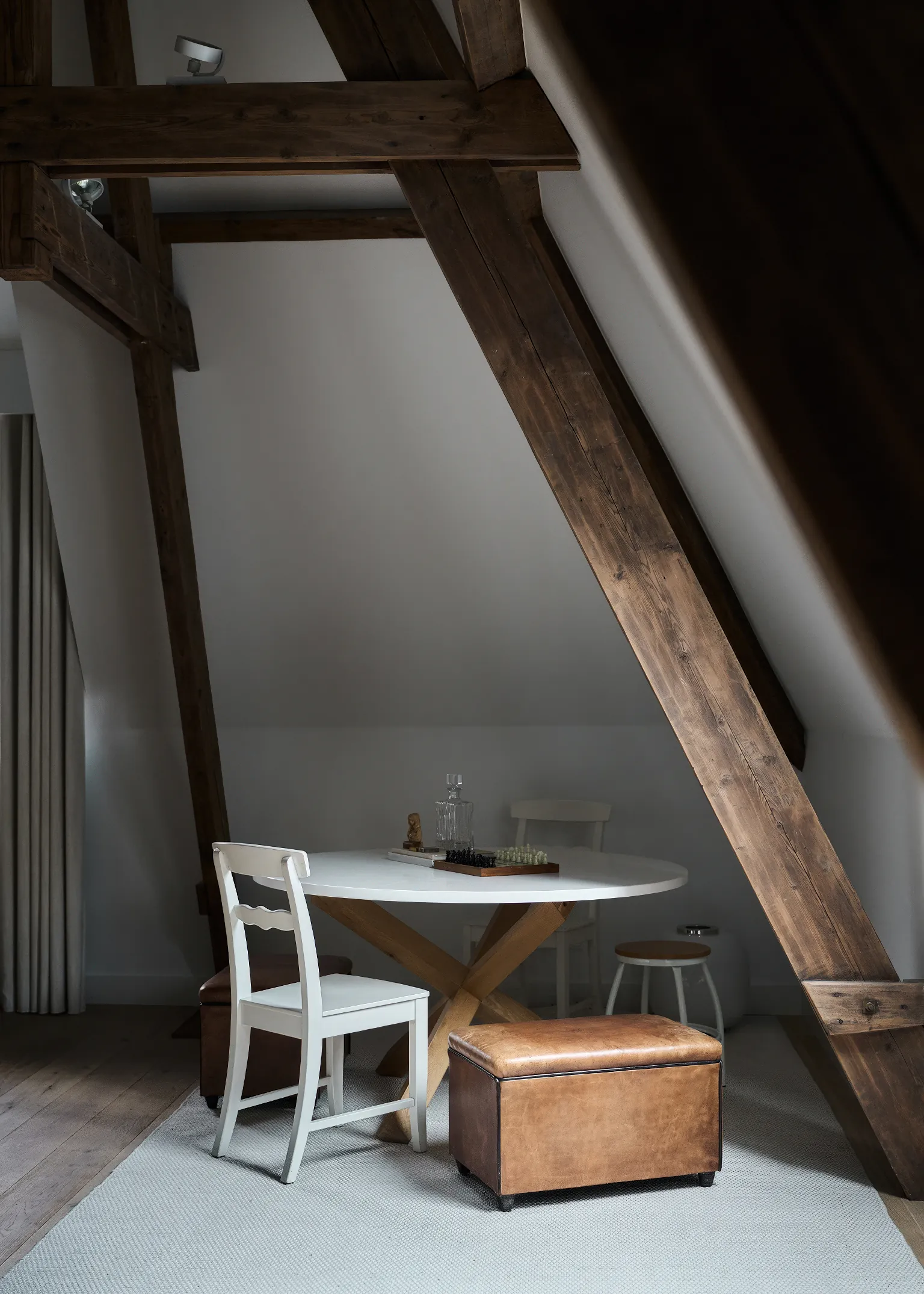 Zolderruimte met authentieke houten balken en gezellig zitje warme sfeer natuurlijk licht karakteristieke architectuur